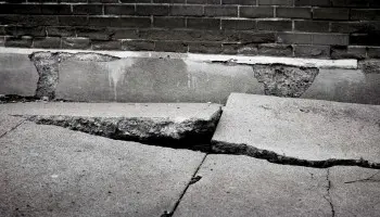 Uneven, cracked concrete that needs to be repaired.